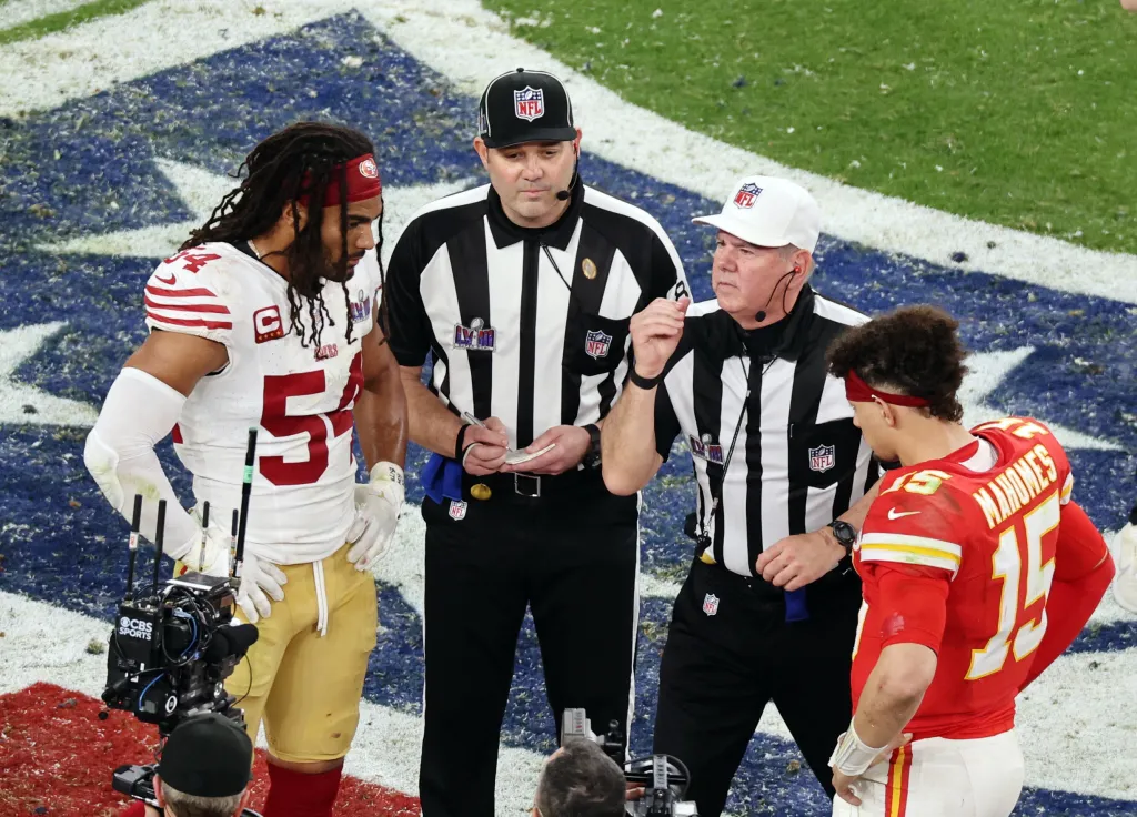 Referee Bill Vinovich performs the coin toss before overtime as San Francisco 49ers’ Fred Warner and Kansas City Chiefs’ Patrick Mahomes watch.
REUTERS