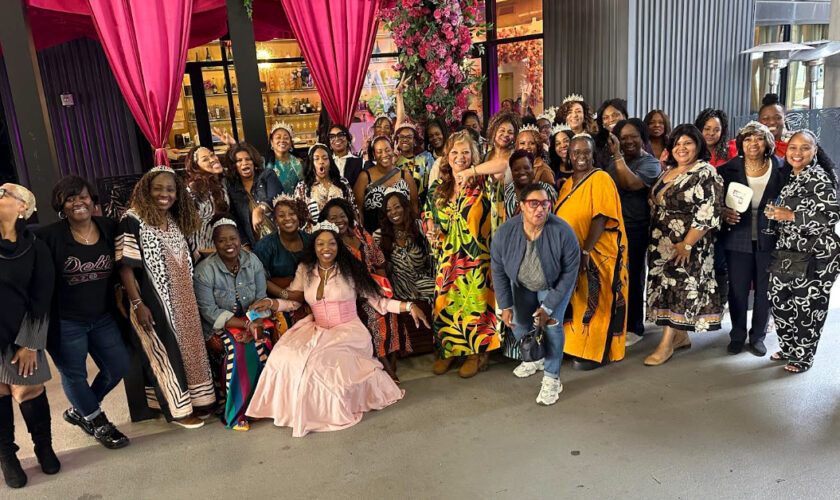Black women over 40 in Atlanta gathered together smiling and celebrating at a sold-out Us Over 40s Friends Group event
